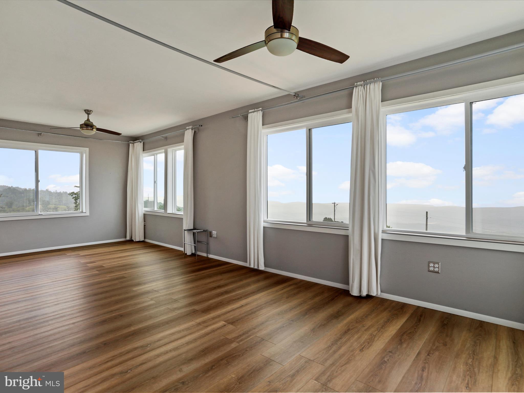 9475 Waxler Road Keyser, WV 26726 - Photo 32 of 61 a view of an empty room with wooden floor and a window