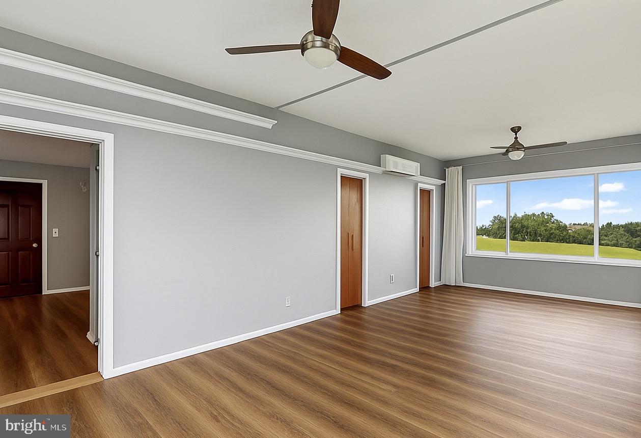 9475 Waxler Road Keyser, WV 26726 - Photo 34 of 61 a view of an empty room with wooden floor and a window