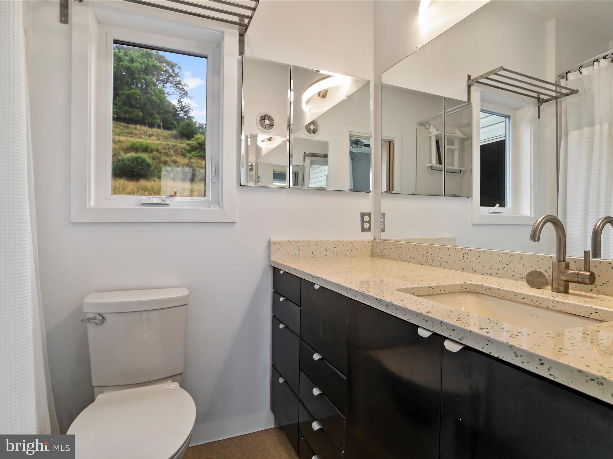 9475 Waxler Road Keyser, WV 26726 - Photo 35 of 61 a bathroom with a granite countertop toilet sink and mirror