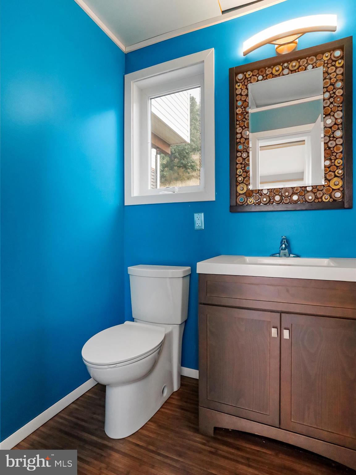9475 Waxler Road Keyser, WV 26726 - Photo 9 of 61 a bathroom with a toilet a sink and mirror