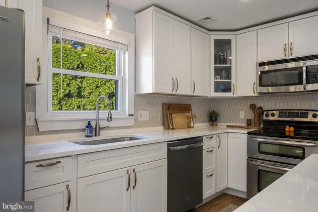 a kitchen with a sink stove and microwave