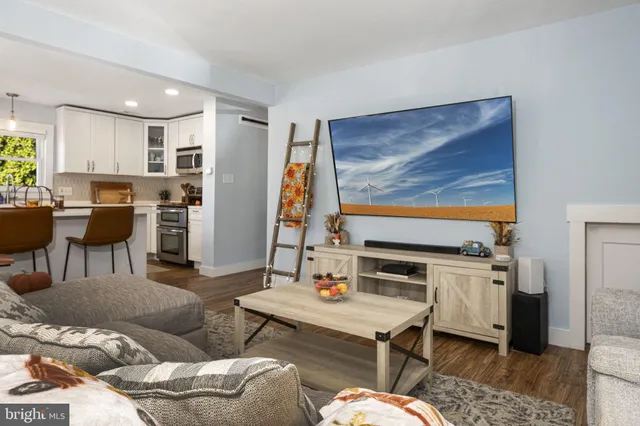 a living room with furniture and flat screen tv