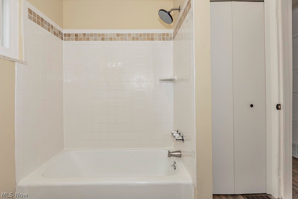 3090 Warren Road Cleveland, OH 44111 - Photo 33 of 50 Bathroom featuring tiled shower / bath combo and hardwood / wood-style floors