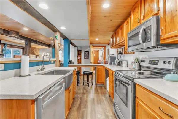 a kitchen with stainless steel appliances granite countertop sink stove and cabinets