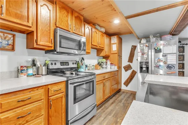 a kitchen with stainless steel appliances granite countertop a sink a stove and cabinets