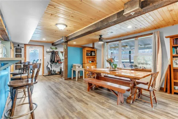 a dining room with furniture and wooden floor