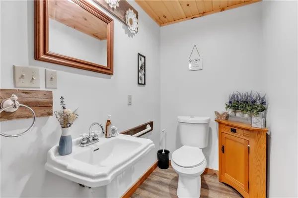 a bathroom with a sink toilet and mirror