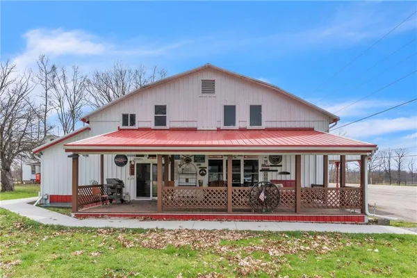 a front view of a house with a yard table and chairs