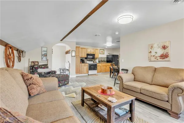 a living room with furniture flat screen tv and outdoor view