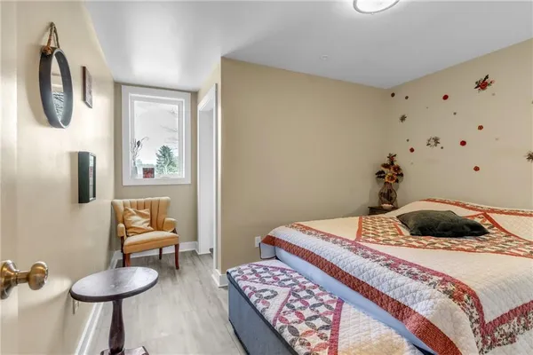 a bedroom with two beds and painting on the wall