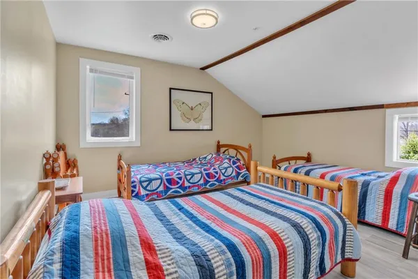a bathroom with a light fixture a mirror and a sink