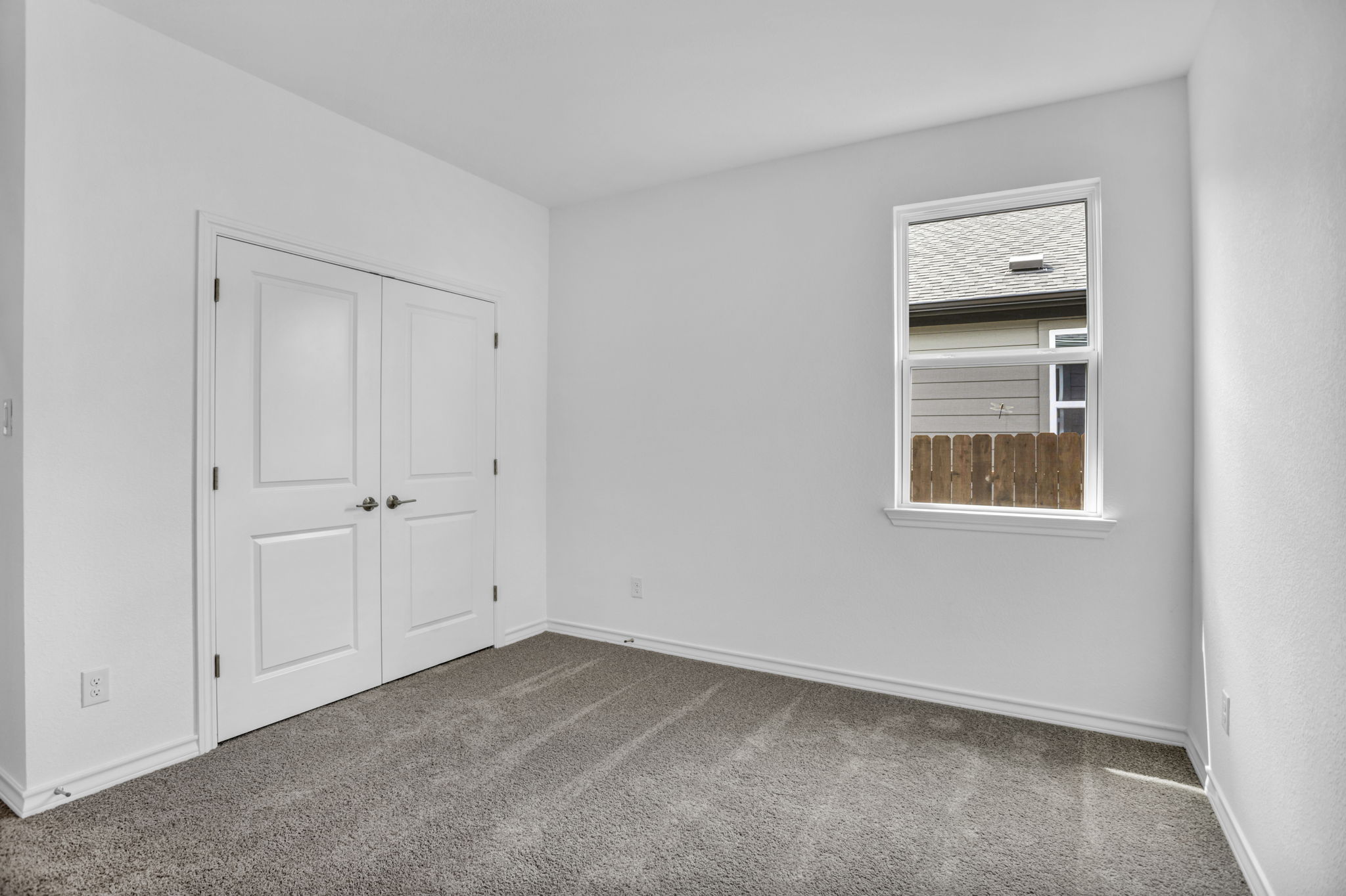 131 Adeline Road Hutto, TX 78634 - Photo 9 of 30 A well-lit room with soft carpeting offers a versatile living space.