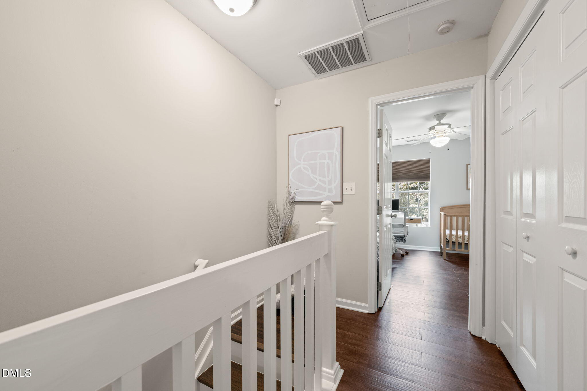 4323 Pine Springs Court Raleigh, NC 27613 - Photo 18 of 38 a view of a hallway with wooden floor and a living room