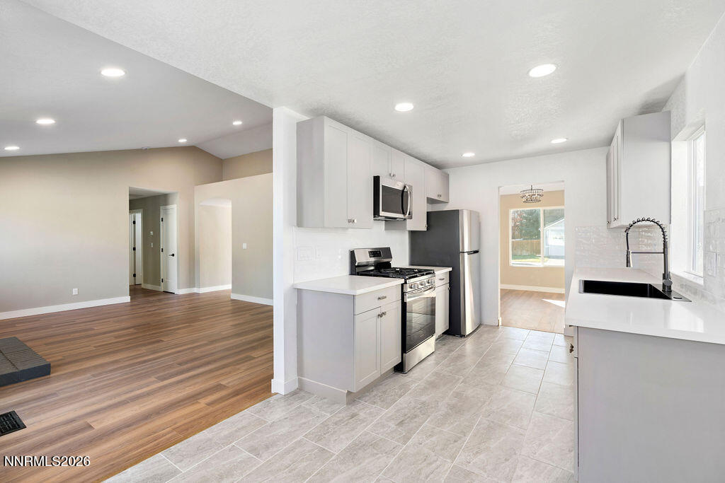 4804 Pinesprings Drive Reno, NV 89509 - Photo 11 of 32 a large kitchen with stainless steel appliances granite countertop a stove a sink and a refrigerator