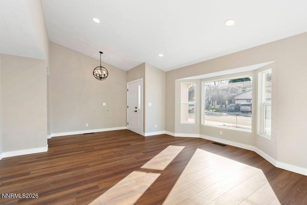 4804 Pinesprings Drive Reno, NV 89509 - Photo 3 of 32 a view of an empty room with a window and wooden floor