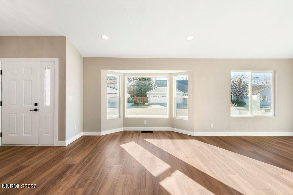 4804 Pinesprings Drive Reno, NV 89509 - Photo 4 of 32 a view of an empty room with wooden floor and a window