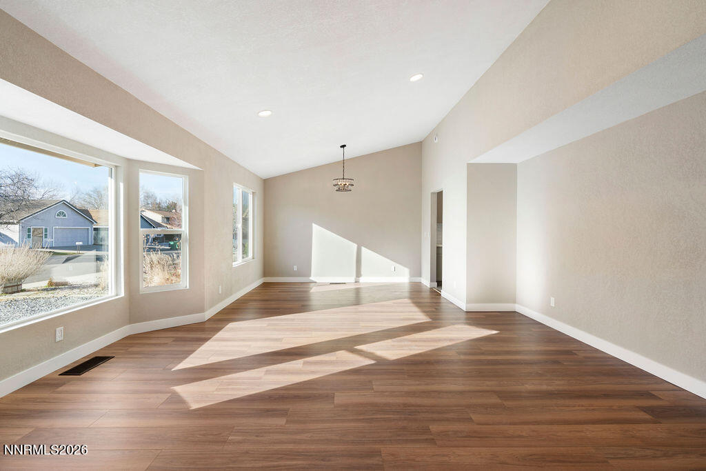 4804 Pinesprings Drive Reno, NV 89509 - Photo 6 of 32 a view of an empty room with wooden floor and a window