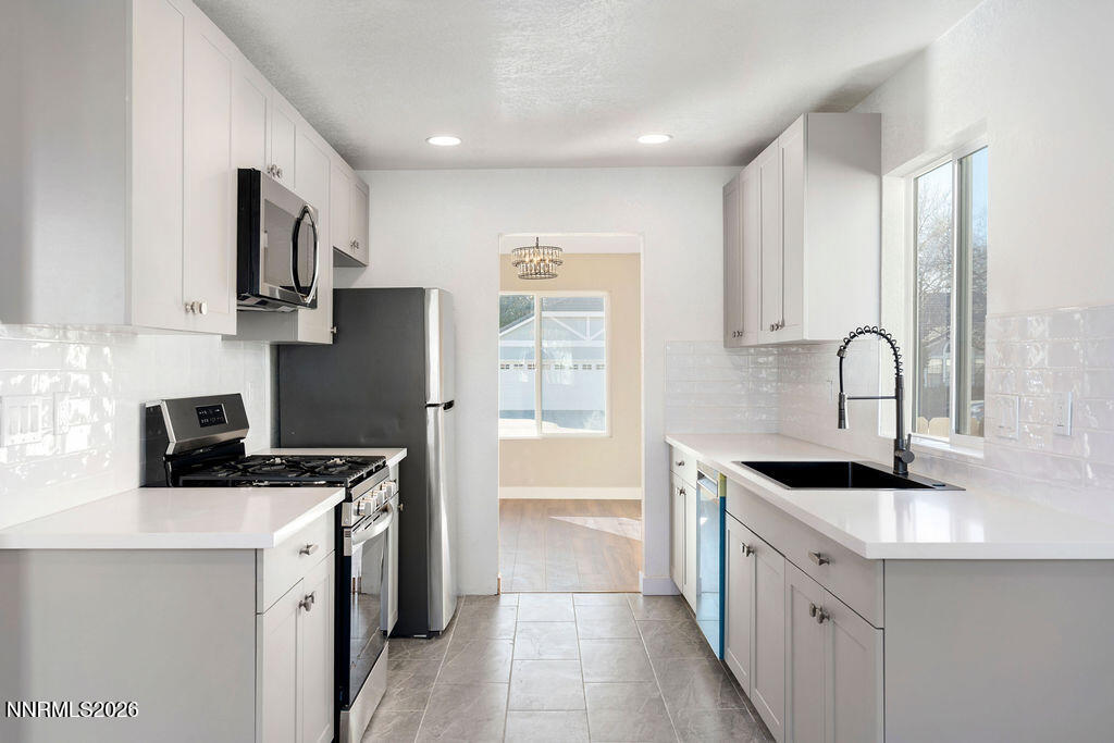 4804 Pinesprings Drive Reno, NV 89509 - Photo 9 of 32 a kitchen that has a sink and a stove in it
