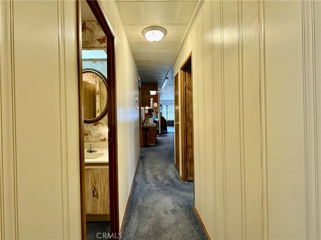 4878 Leonard Road, Unit 11 Mariposa, CA 95338 - Photo 15 of 15 a view of a hallway with wooden shelves