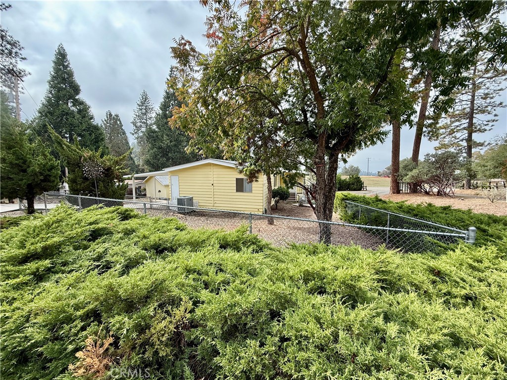 4878 Leonard Road, Unit 11 Mariposa, CA 95338 - Photo 4 of 15 a backyard of a house with lots of green space and fountain
