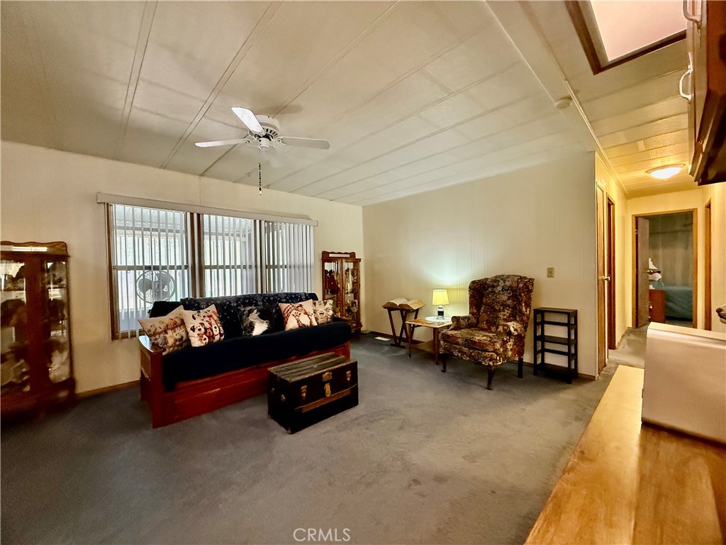 4878 Leonard Road, Unit 11 Mariposa, CA 95338 - Photo 7 of 15 a living room with furniture and a chandelier