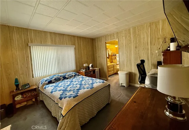 a bedroom with bed and a window