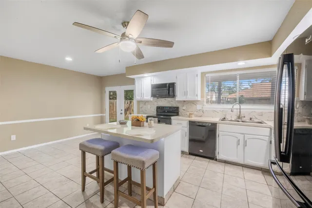 a kitchen with refrigerator cabinets and furniture