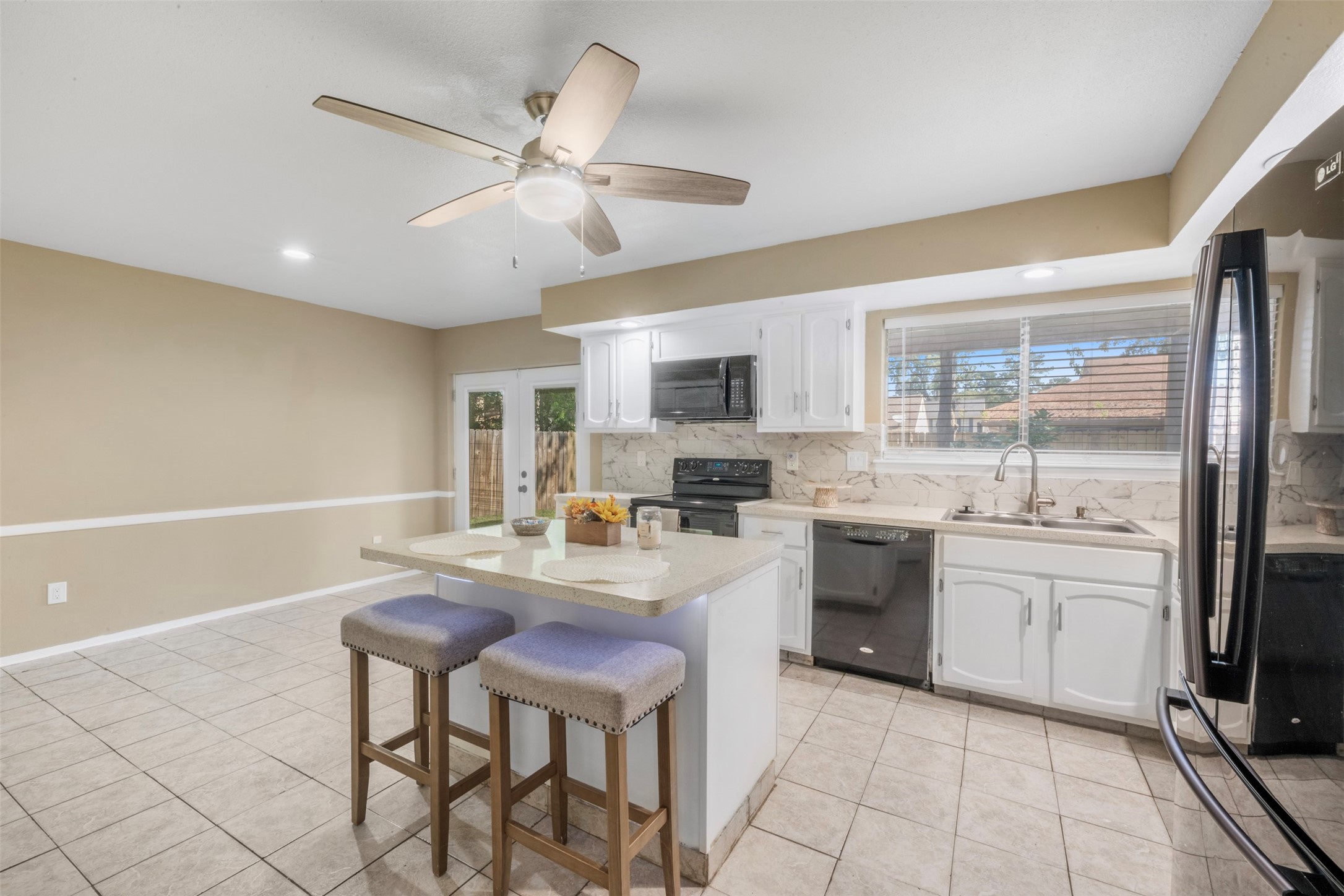 25306 Mill Pond Lane Spring, TX 77373 - Photo 13 of 37 a kitchen with refrigerator cabinets and furniture