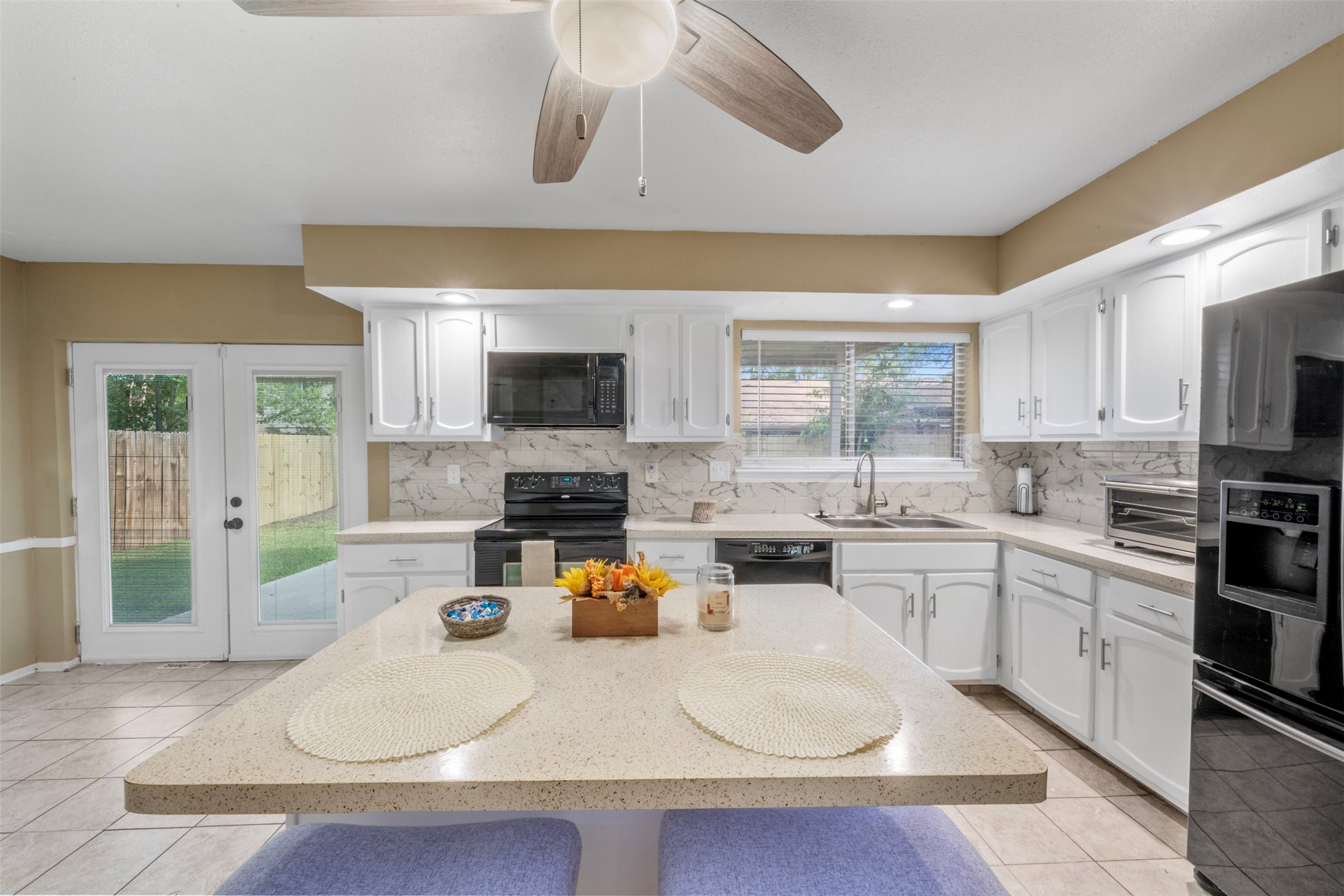 25306 Mill Pond Lane Spring, TX 77373 - Photo 14 of 37 a kitchen with a sink a stove top oven and cabinets