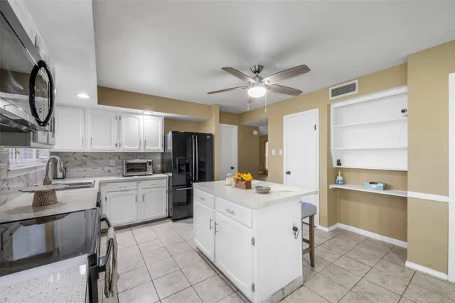 a kitchen with a sink cabinets and window