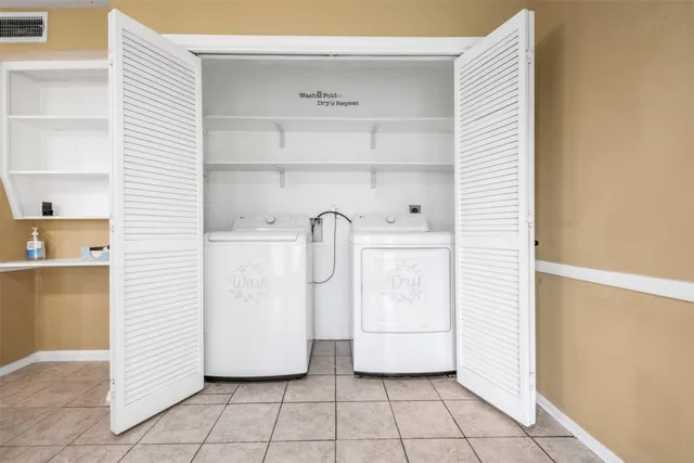 a utility room with cabinets and washer