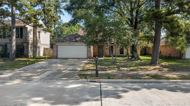 a view of a house with a tree in front of it