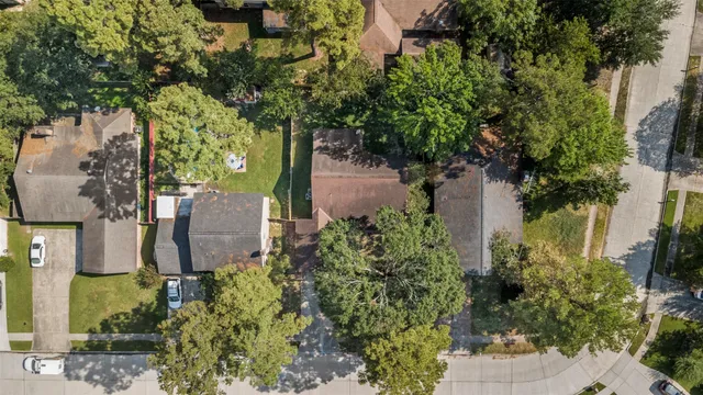 an aerial view of a house with a yard and garden