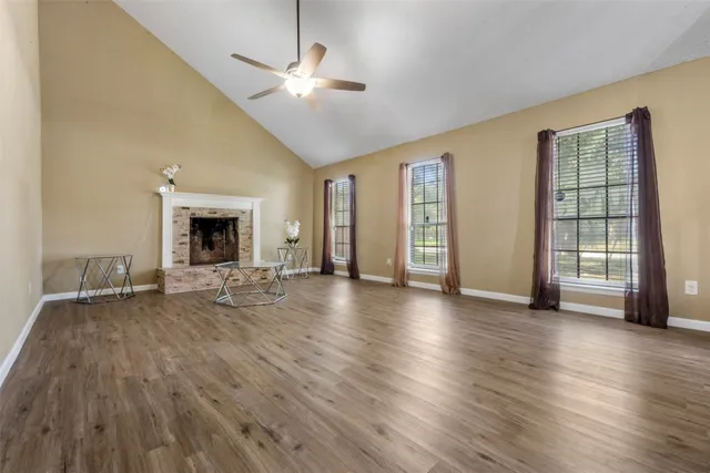 a view of a livingroom with wooden floor and a ceiling fan