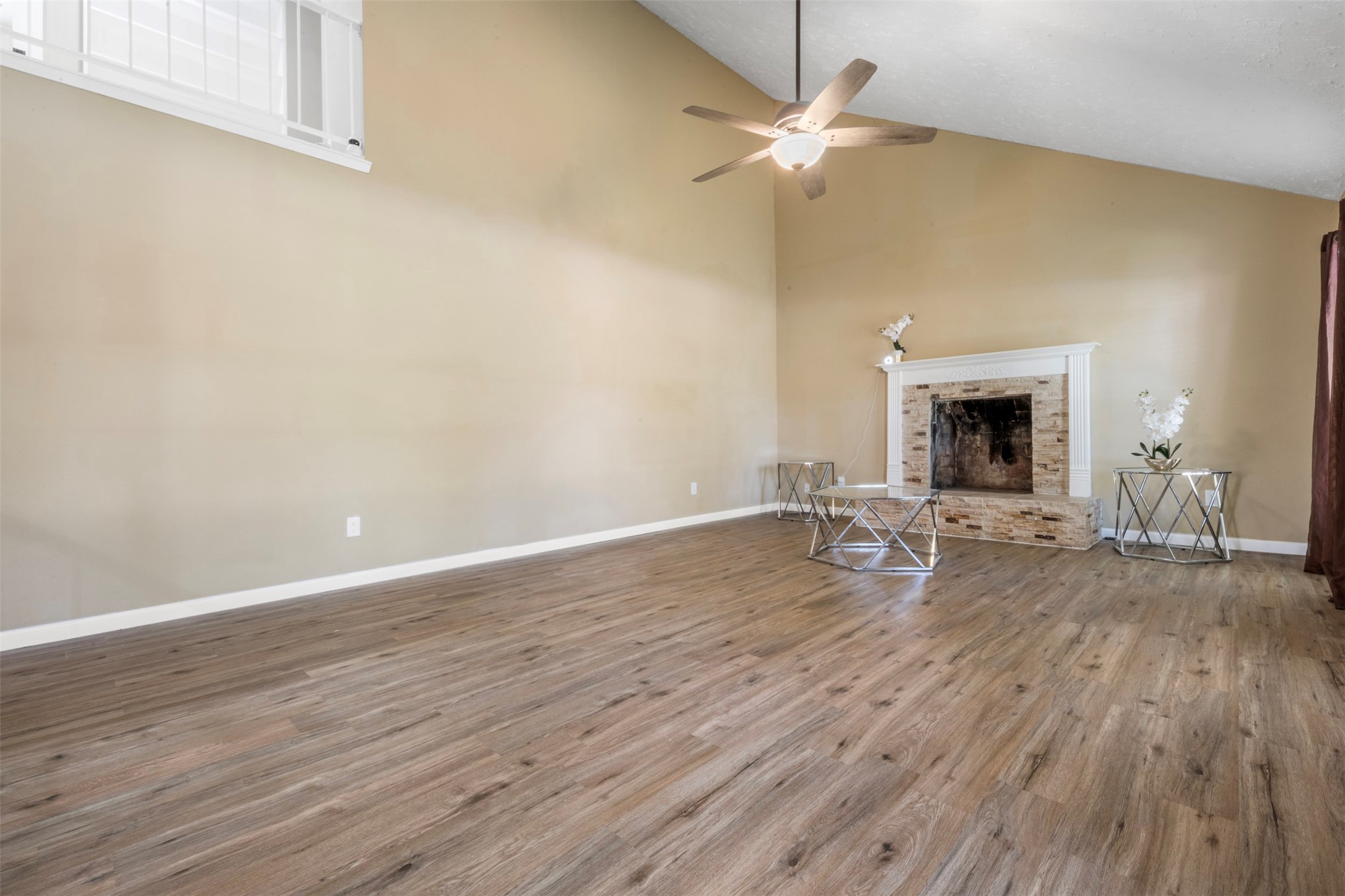 25306 Mill Pond Lane Spring, TX 77373 - Photo 5 of 37 a view of a livingroom with wooden floor a ceiling fan and fireplace