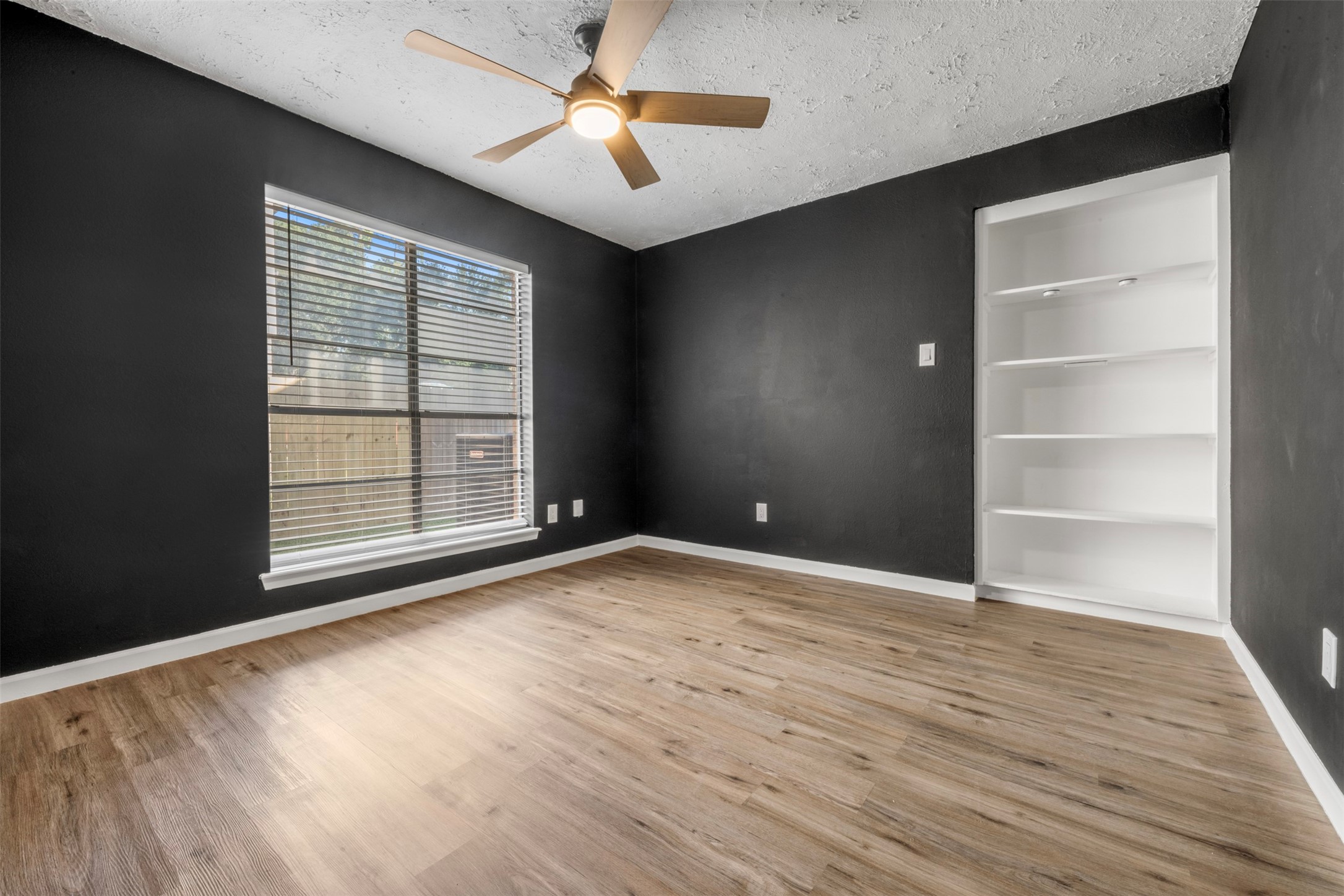 25306 Mill Pond Lane Spring, TX 77373 - Photo 7 of 37 wooden floor in an empty room with a window