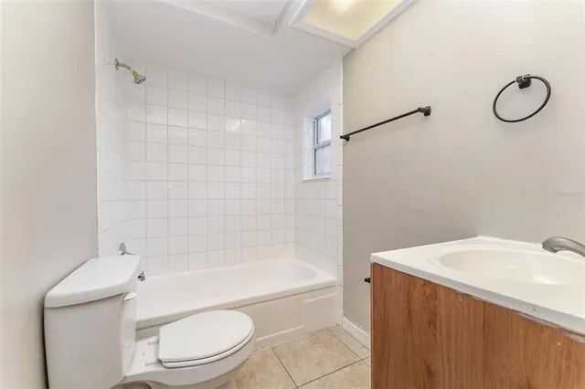 a bathroom with a toilet a sink and bathtub