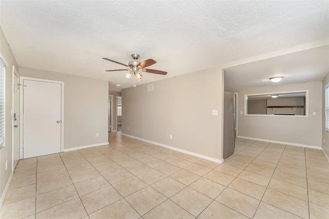 an empty room with closet and windows