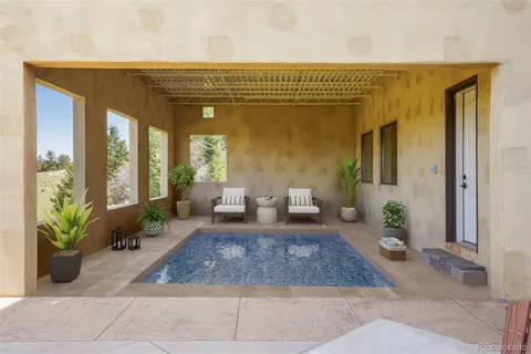 a view of a chairs and table in patio