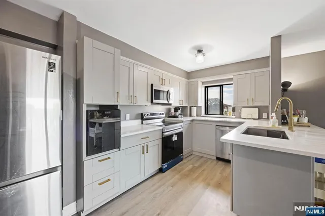 a kitchen with white cabinets and white appliances
