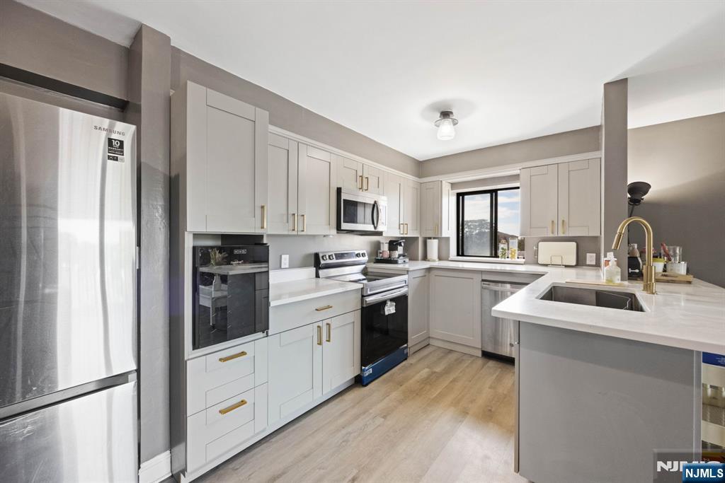 a kitchen with white cabinets and white appliances