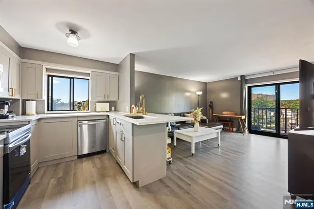 a kitchen with a sink and wooden floor
