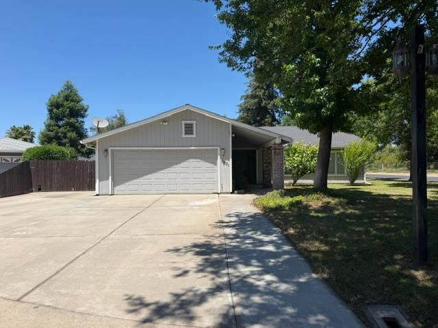 2601 Temperate Court Modesto, CA 95358 - Photo 3 of 24 a front view of a house with a yard and garage