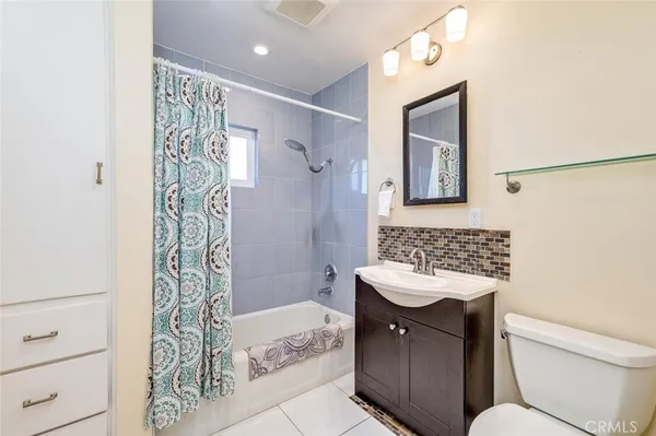 a bathroom with a sink toilet a shower and a mirror