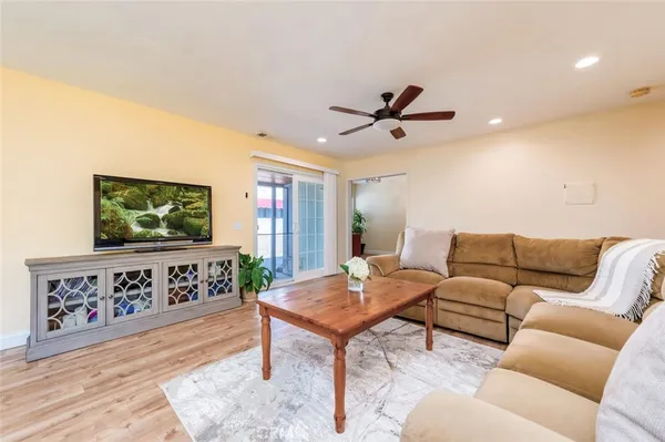a living room with furniture a window and a flat screen tv