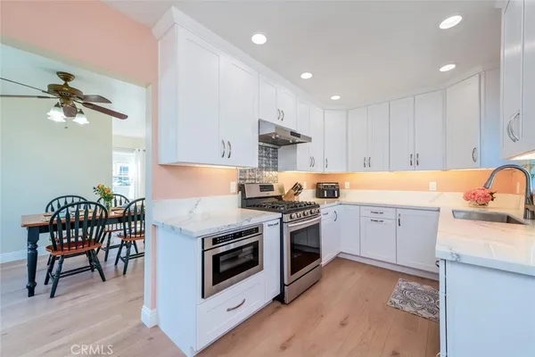 a kitchen with a stove a sink and a refrigerator