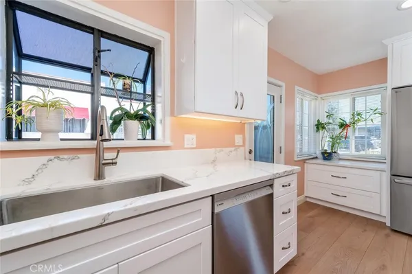 a kitchen with a sink and a large window