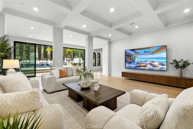 a living room with furniture and a view of kitchen
