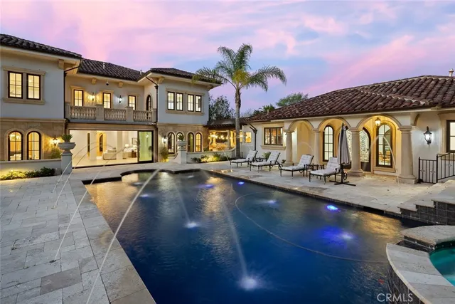 an aerial view of houses with outdoor space and swimming pool
