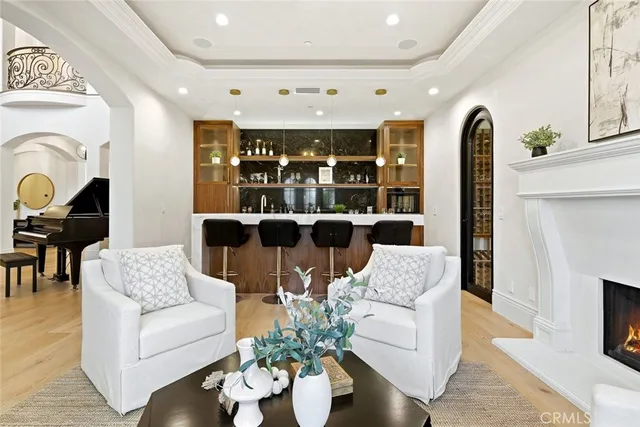 a hallway with wooden floor stairs and a potted plant